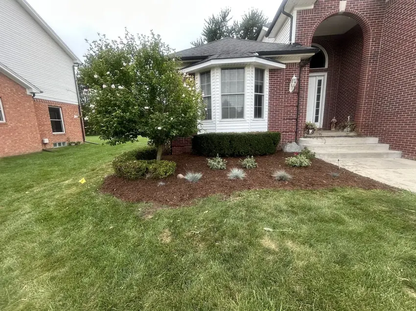 Fresh mulch bed with new plantings around a brick home in Troy, MI
